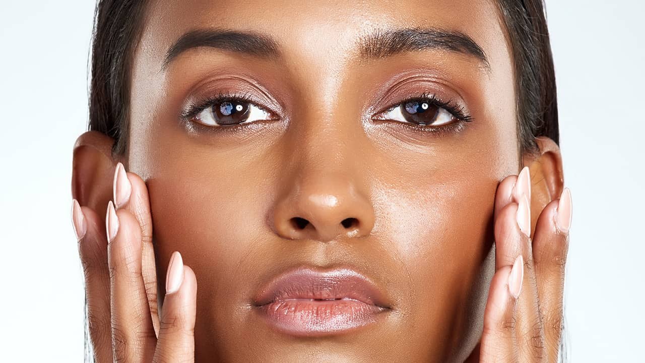 Heavy shine across a forehead and cheek — oily skin.